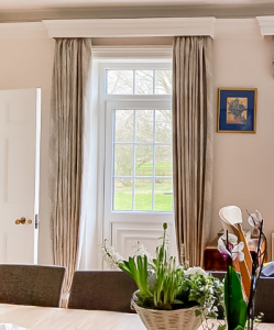 pleated curtains with a wooden pelmet box